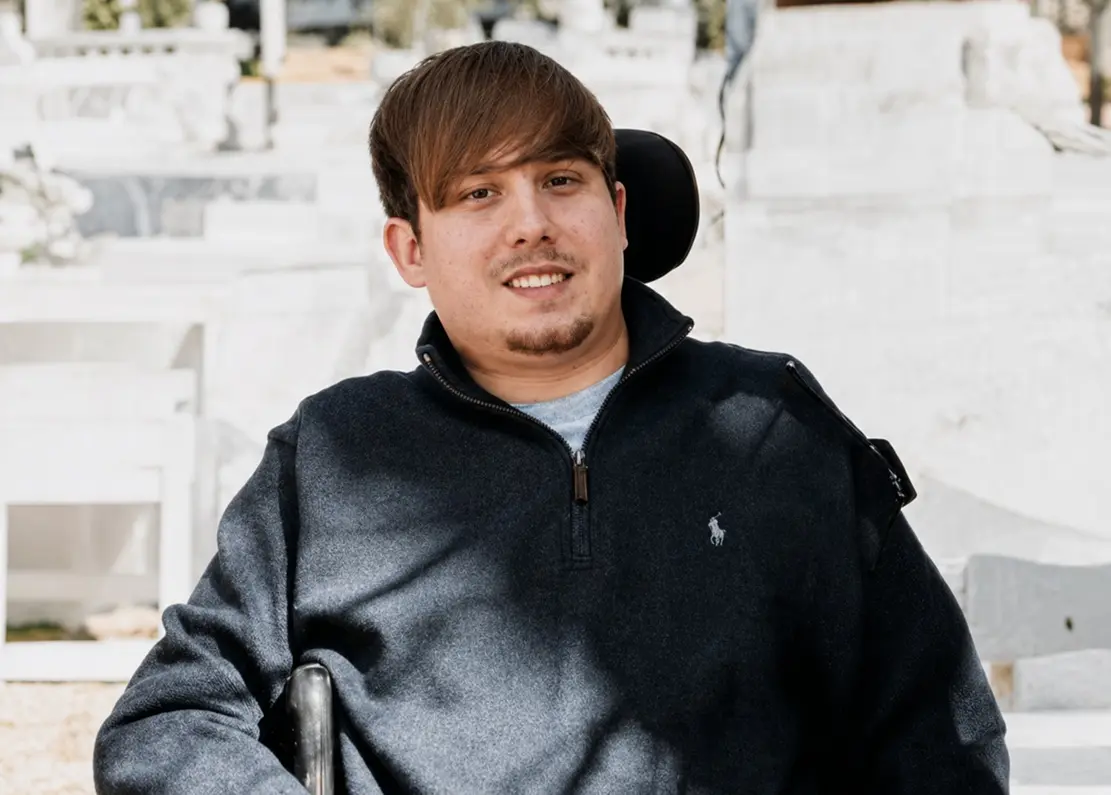 Michael Read, founder of Magnetic Web Development, smiling outdoors in his wheelchair.