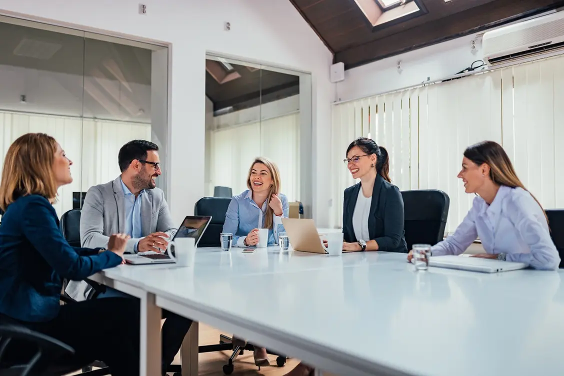 Professional web design team collaborating in a modern office during a website strategy and branding meeting.